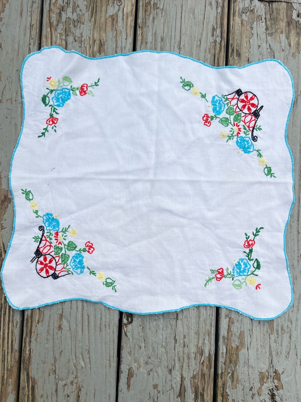 Vintage White Embroidered Table Linen with Blue and Red Floral Accents